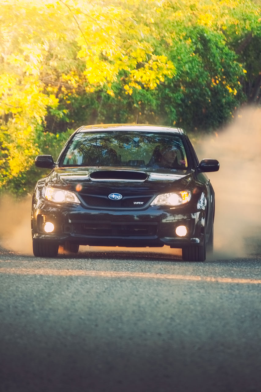 Black 5 Door Subaru WRX at home on a rural loose surface kicking up dust