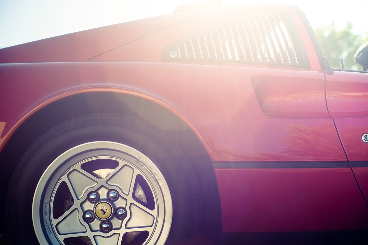 Red Ferrari 308 GTSi wheels on a sunny morning