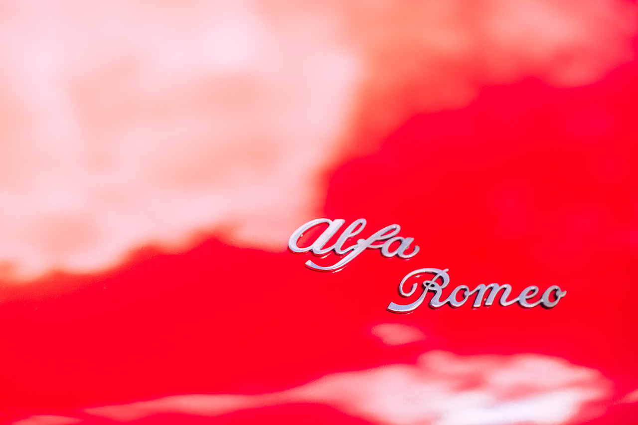 Classic Alfa Romeo Spider boot badging on a perfect driving day